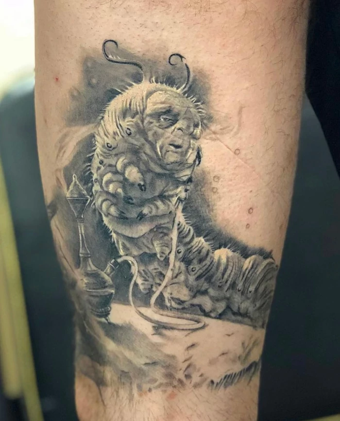 Fine line realistic black and grey thigh tattoo of Alice in Wonderland smoking caterpillar by Russ Howie of Sacred Mandala Studio.